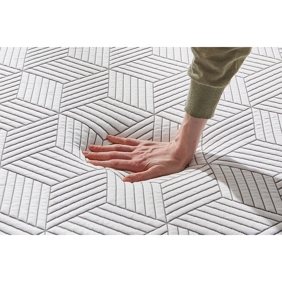 MLILY Harmony Chill 2.0 Memory Foam Medium 14" Mattress with a person's hand pressing down on the mattress to demonstrate comfort and support from the memory foam, also showing the detail of the mattress cover.