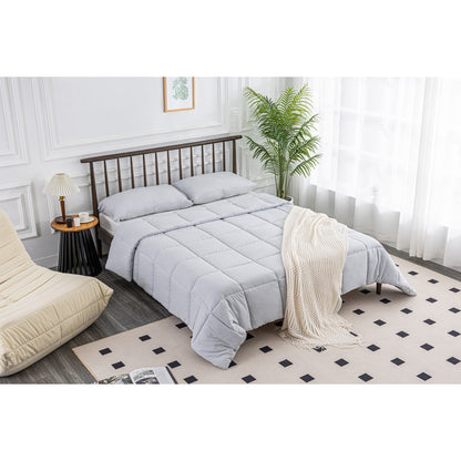 Aerial view of the MLILY Soft Washed Down Alternative Comforter set in grey, with the bed neatly made, showcasing the polyester-based comforter and shams, in a beautifully decorated bedroom.