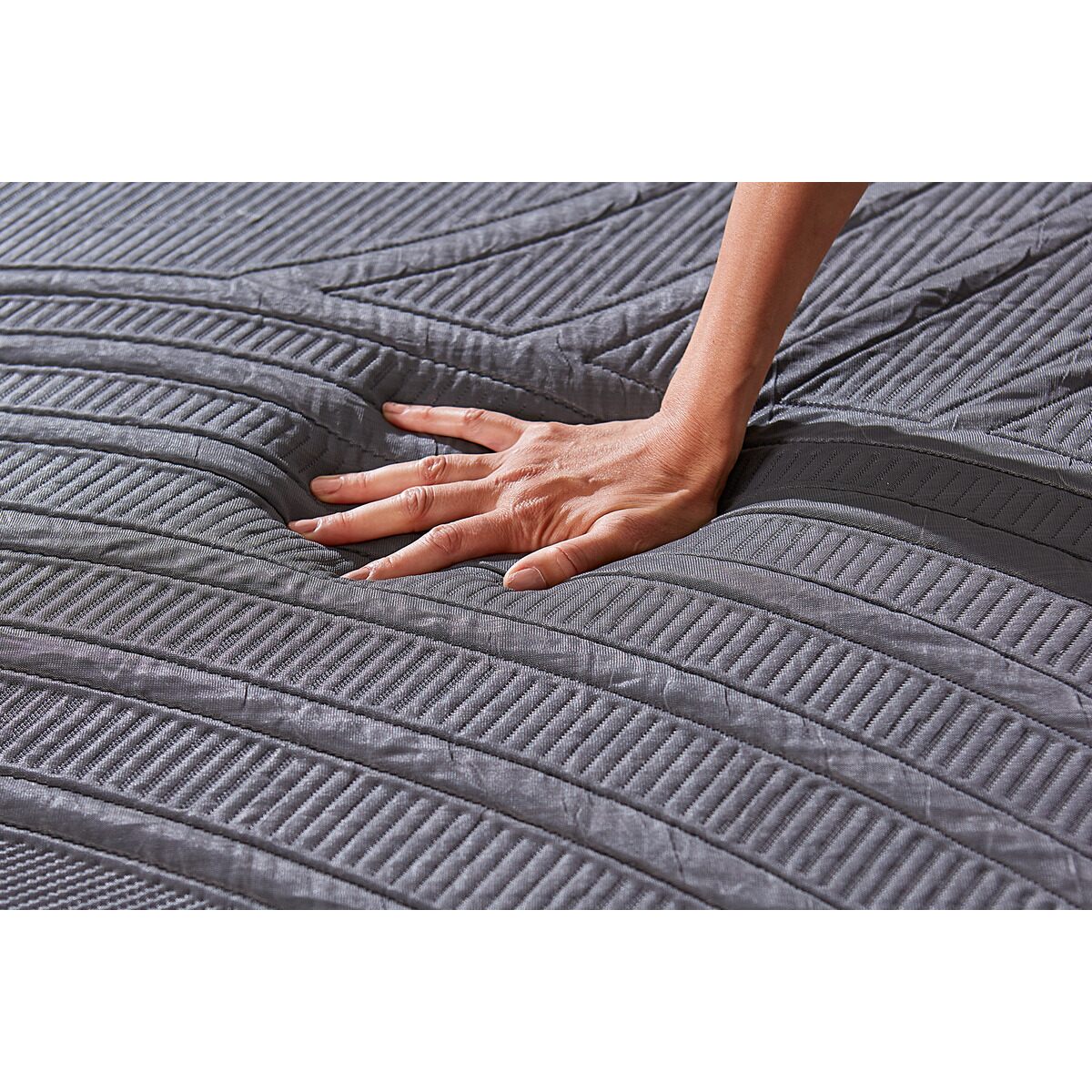 Close-up of MLILY PowerCool Hybrid Medium 11.5-inch Mattress with woman's hand pressing down, showing comfort, support, pressure relief, motion isolation, and cooling knit fabric cover details.