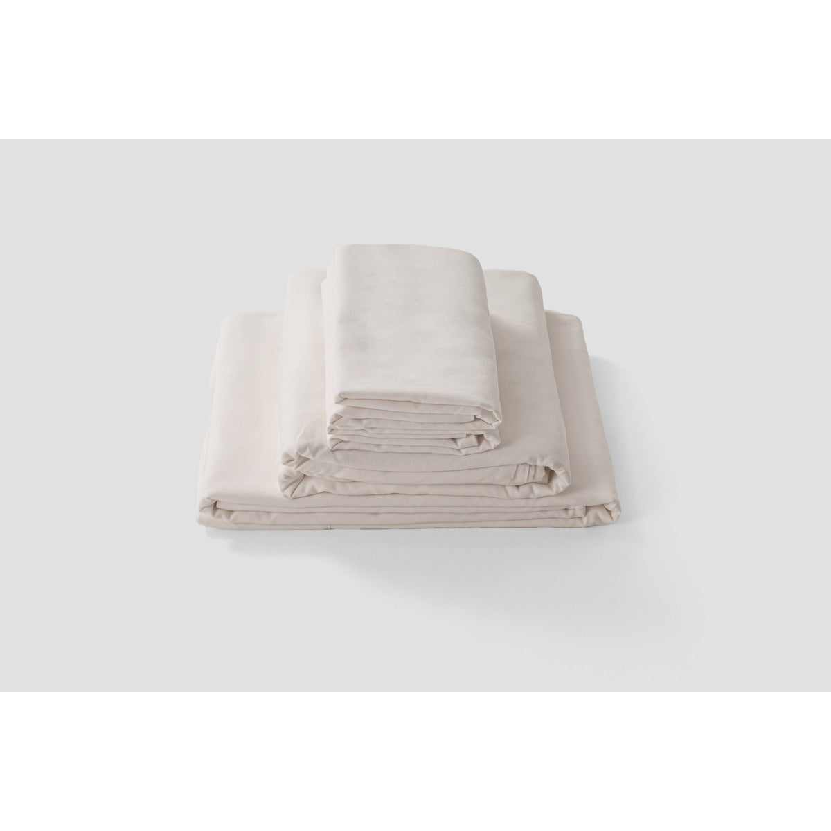 Folded and stacked MLILY Soft Washed Sheet Set, white background, showing soft and comfortable materials.