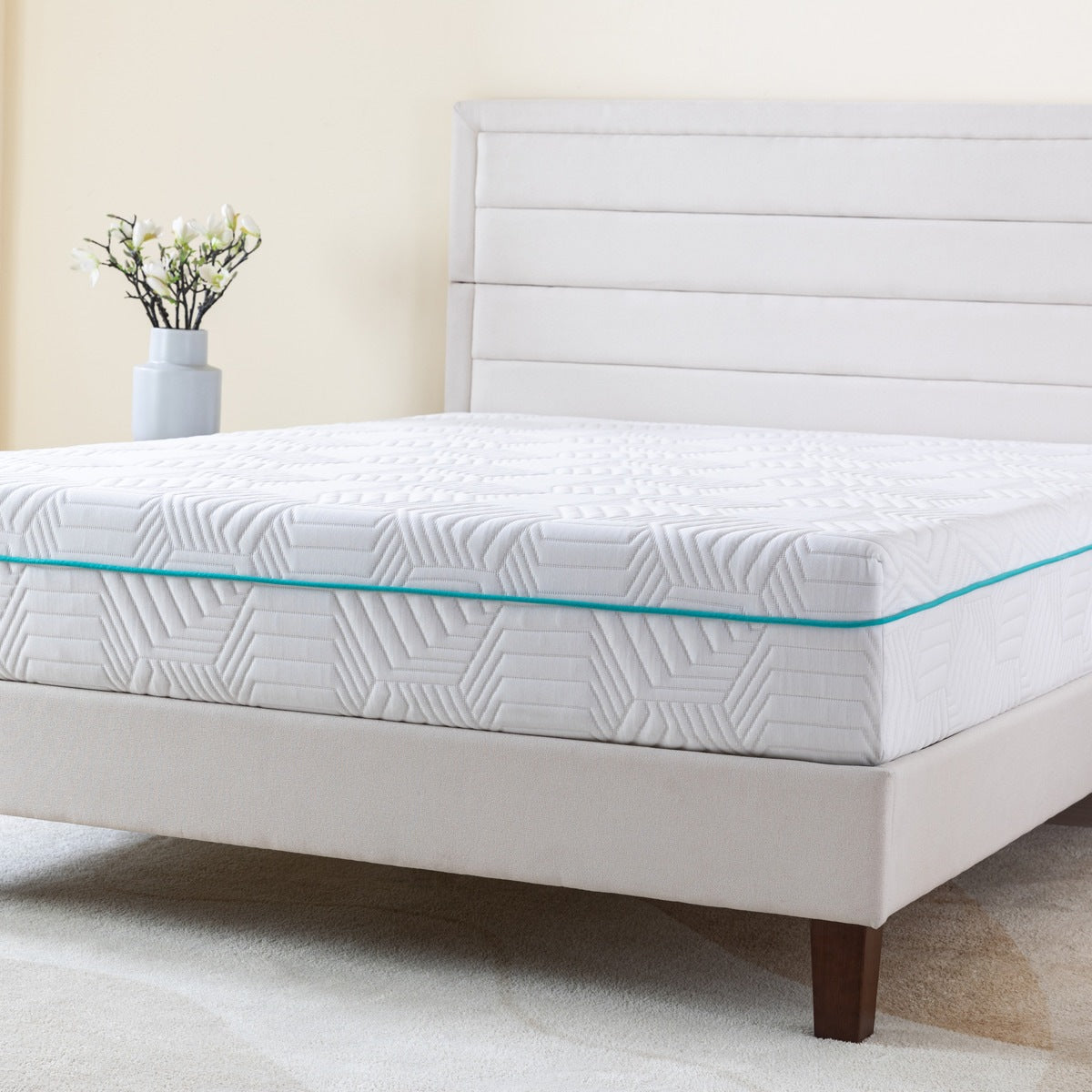 MLILY Essential Plus Memory Foam Medium 10" Mattress zoomed in, viewed from a corner angle, showing the front and side of the mattress, sitting on a platform bed frame, inside a decorated bedroom.