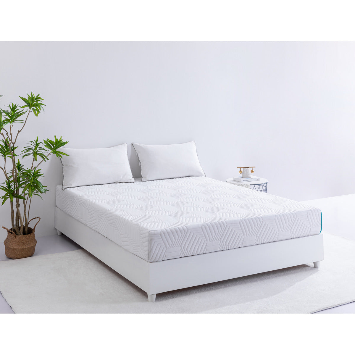 MLILY Essential Plus Memory Foam Medium 8" Mattress with two pillows at the head of the bed, showing the front, side, and corner of the mattress, sitting on top of a platform bed frame, inside a decorated bedroom, angled upward slightly.