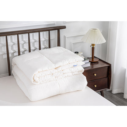 MLILY Soft Washed Down Alternative Comforter Set in white, folded and stacked at the corner of a bed, showing comfortable detail of Cover: 100% Polyester Washed Microfiber Core: 100% Polyester Down Alternative.