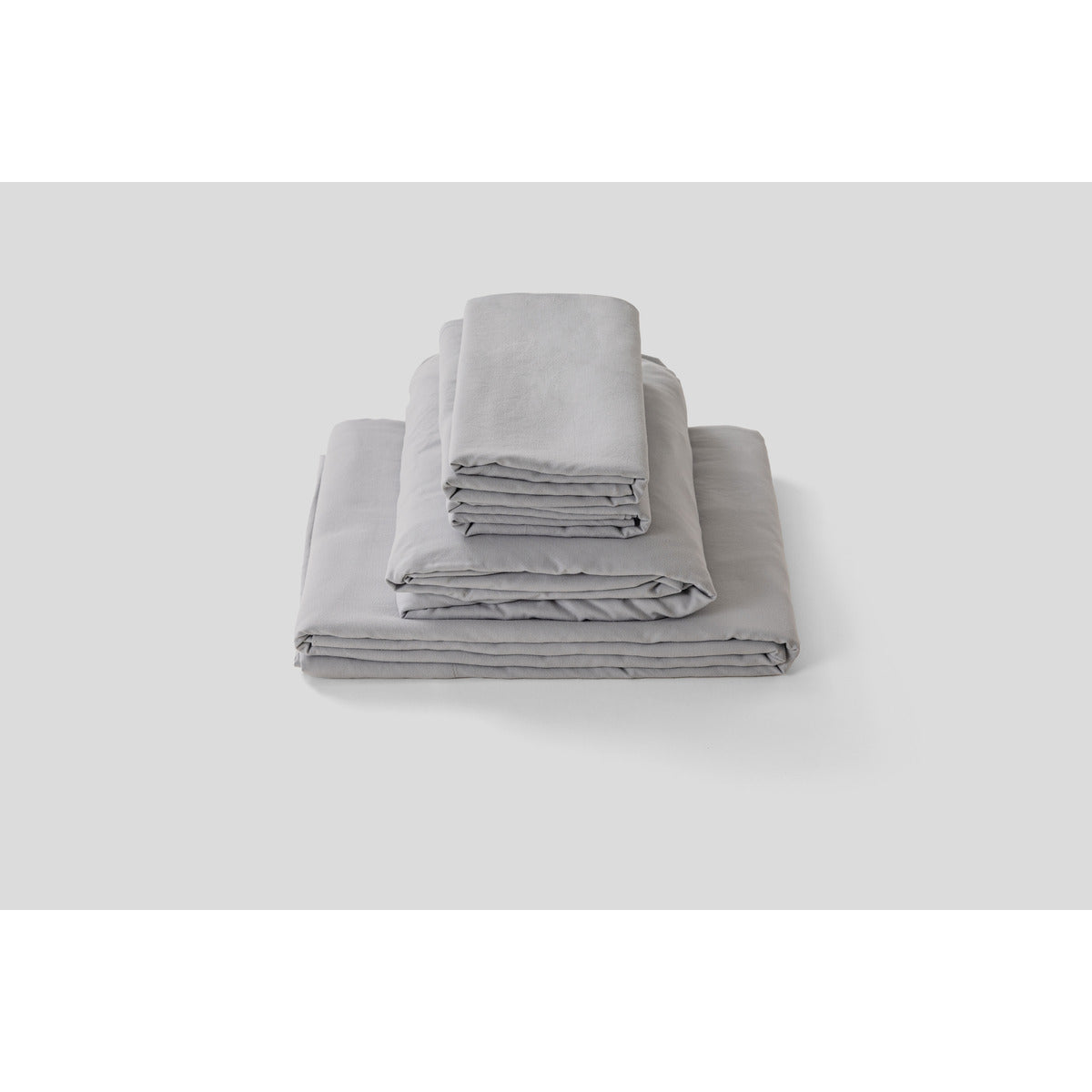 MLILY Soft Washed Sheet Set, folded and stacked, white background, showcasing the soft and comfortable materials.