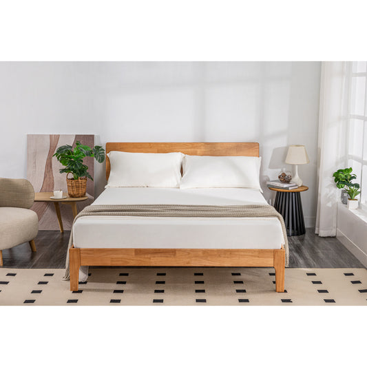 MLILY Soft Washed Sheet Set in white made on a bed, showcasing its ability to accommodate mattresses up to 16 inches tall, in a decorated bedroom.