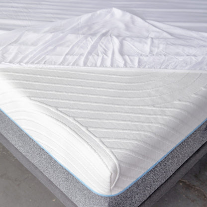 Slight aerial view of the corner of the mattress with the MLILY Tencel Fabric Mattress Protector halfway on, fits mattresses 7 to 15 inches thick, illustrating it as a mattress protector being advertised.