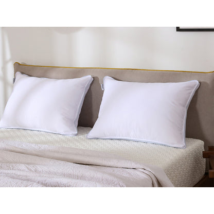 Two MLILY AirCell Classic pillows on a bed, placed up against a headboard inside of a bedroom showing how it will look when your bed is made.